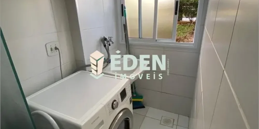 Sala com sofá e mesa integrada à cozinha planejada em apartamento no Parque Campolim em Sorocaba